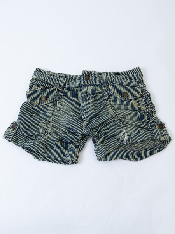 Green-blue striped shorts with distressed details and snap pockets.