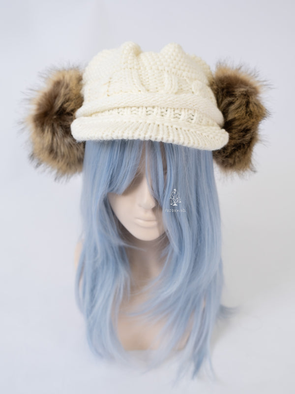 White knitted cap with brown faux fur ear covers and soft ribbed brim.