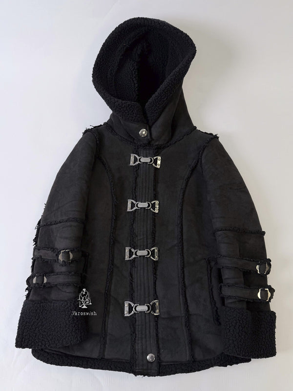 Black shearling coat with buckle closures, raw-edge seams, and thick hood.